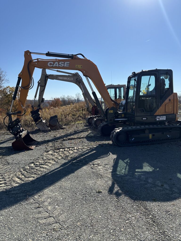 Two construction excavators on site