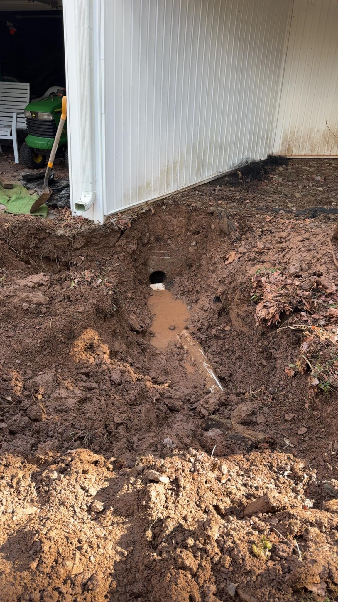 Excavated trench with water drainage hole
